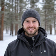 Professional portrait of Content Director Mark Johnson in a winter setting